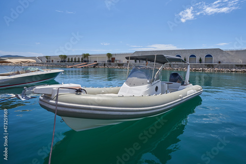 Small pleasure boat with a canopy roof at the dock