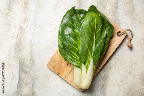 Top view of swiss chard leaves: leafy green high-fiber vegetables, among the most nutrient-dense foods rich of antioxidants. Horizontal image, flat lay, copy space.