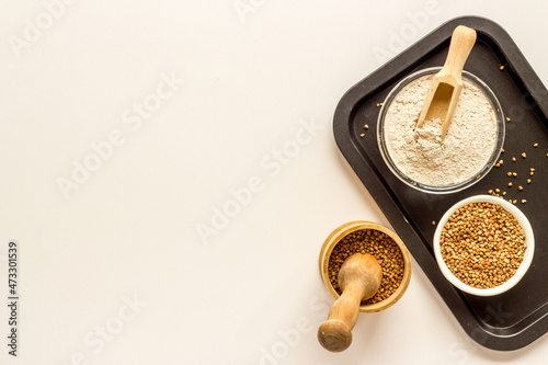 Pestle buckwheat flour - grains with mortar on kitchen table