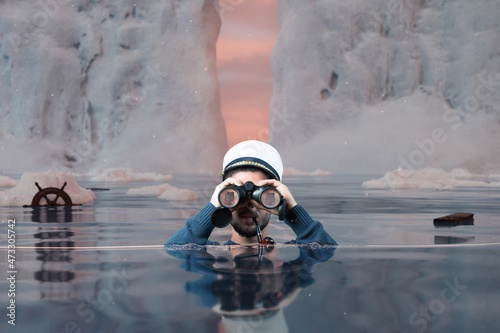 shipwrecked helmsman standing underwater and watching with binoculars the iceberg in the high seas