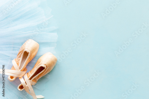 White ballet tutu skirt and beige pointe shoes with ribbon