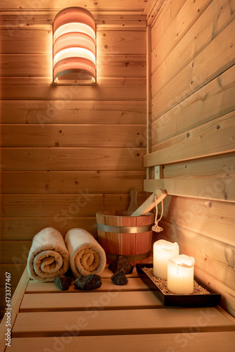 Interior of a small Finnish wooden sauna with sauna accessories.