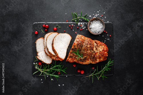Christmas turkey ham roasted for festive dinner on black background. Top view