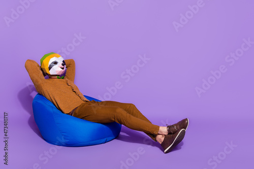 Full size profile side photo of young mant rest longer hands behind head isolated over purple color background