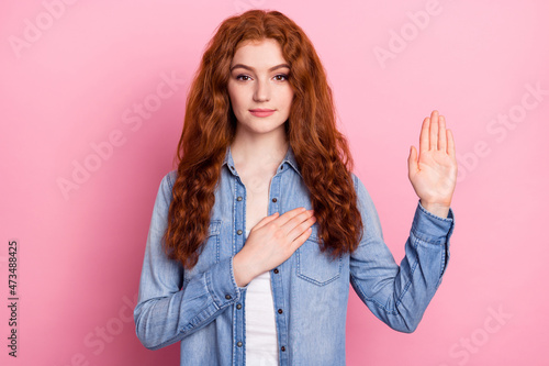 Photo of young girl hand on heart make oath promise tell the truth isolated over pastel color background