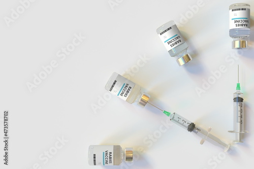 Clock face made with rabies vaccine vials and syringes. Vaccination time concept. Conceptual medical 3D rendering