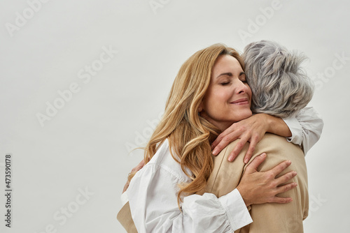 Loving adult daughter embrace old mother feel grateful