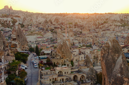 Goreme, Turkey-October 9, 2021:Picturesque sunset landscape view of ancient cave houses in Goreme. Popular travel destination in Turkey. UNESCO World Heritage Site