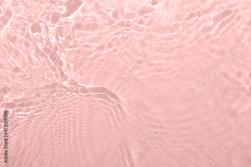 Fresh water background. Light gossamer pink pattern with natural rippled water texture. Top view with copy space. Cosmetic water surface background. 