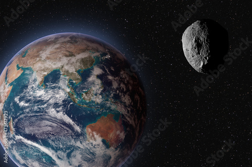 Asteroid approaching planet Earth, elements of this image furnished by NASA