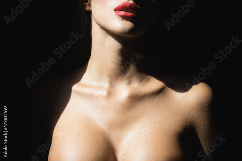 Sexy lips and tits boobs, breast. Beautiful young woman portrait on black. Sensual face of elegant female model in studio. Elegant lady.