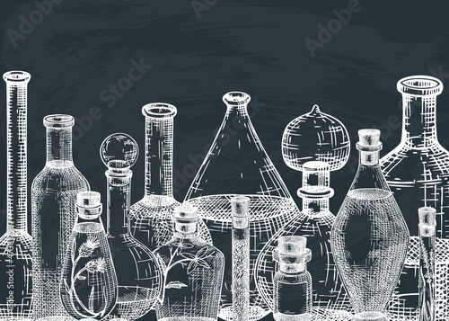 Hand-sketched glass equipment for perfumery and cosmetics making on chalkboard. Chemicals and alchemy glassware background. Perfume bottles, jars, flasks design in engraved style. Vintage drawing