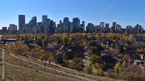 Stunning panoramic view of the skyline of Calgary, Alberta, Canada viewed from Crescent Heights in autumn season with colorful trees.