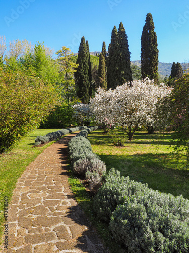 Botanical Garden of Ninfa of ancient Caetani family are surrounded by flowering colorful exotic plants. Beautiful Monti Lepini valley near Sermoneta, Cisterna di Latina. Amazing Italian landscape.