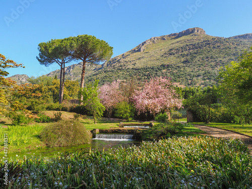 Amazing Garden of Ninfa created in the ruins of a medieval city by the Caetani family. Monti Lepini valley near Norma and Sermoneta. Cisterna di Latina, Province of Latina, Italy. Beautiful landscape.