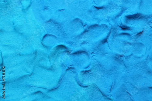 Light blue play dough as background, top view