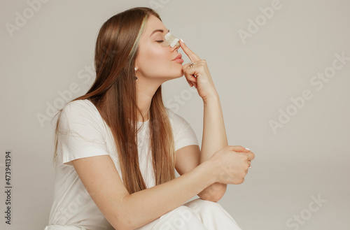 A young woman with a bandage on her nose after rhinoplasty