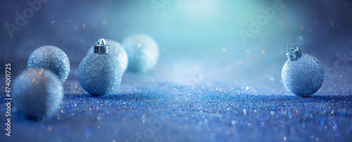 glitter baubles on a blue glitter background, background for Christmas