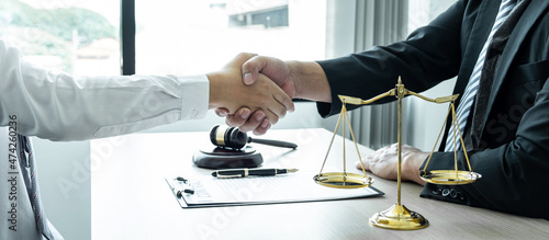 Male lawyer shaking hands with client after good deal negotiation cooperation meeting in courtroom