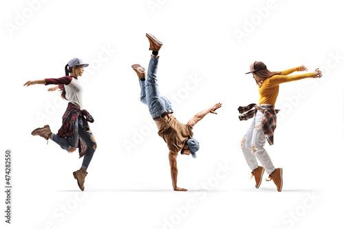 Two female dancers and one male dancer performing a hand stand