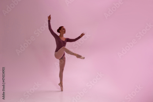 Caucasian girl dancing ballet dance in studio