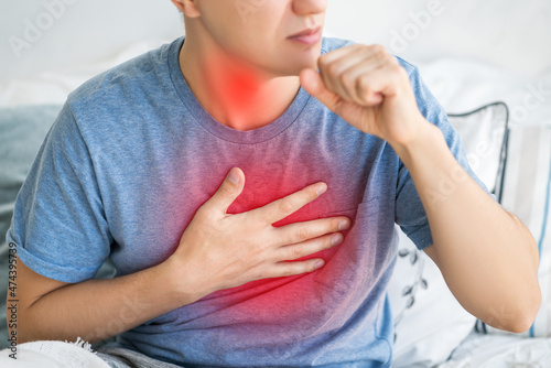 Sore throat and cough, man with lung pain at home