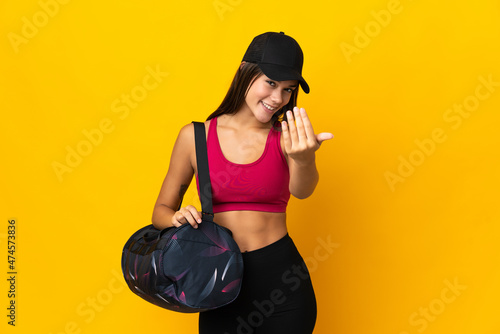 Teenager sport girl with sport bag inviting to come with hand. Happy that you came