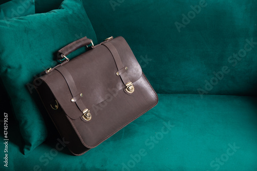 brown genuine leather briefcase with metal clasps, insulated on a white background