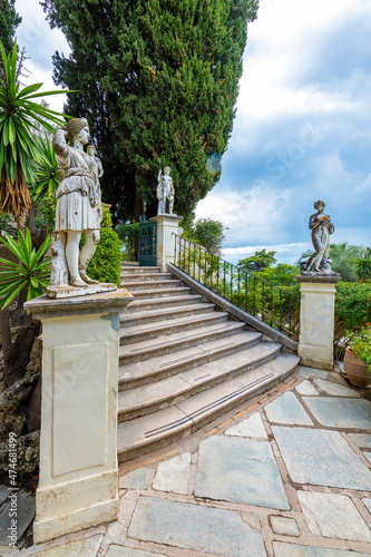 Achilleion palace, Corfu, Greece - October 24, 2021: Classical statues at the Achillion Palace on the island of Corfu.