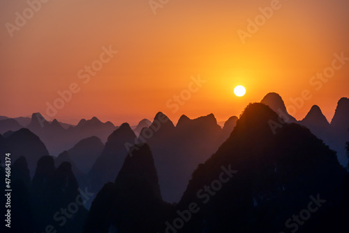 The sunrise silhouette of Guilin landscape in Guangxi, China is like Chinese landscape painting in the style of ink painting