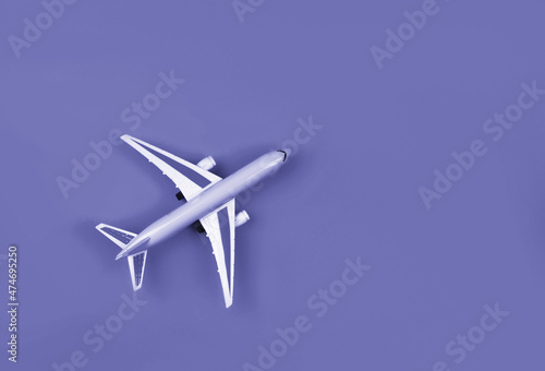 Airplane, miniature on very peri lavender background.