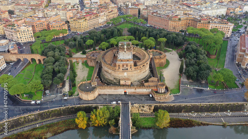 Aerial drone view of iconic Castel Sant'Angelo (castle of Holy Angel) and Ponte or bridge Sant'Angelo with statues in river of Tiber next to famous Vatican, Rome, Italy