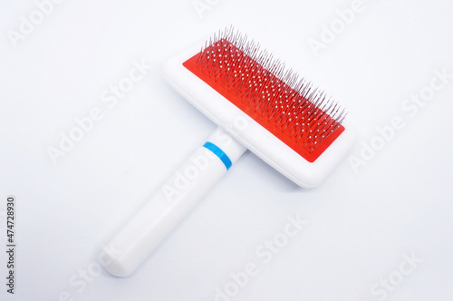 Slicker brush, To remove hairballs or clumps of fur, choose a slicker brush. This comb is able to lift the cat's hair from the roots little by little until the tangles of the fur are unraveled.