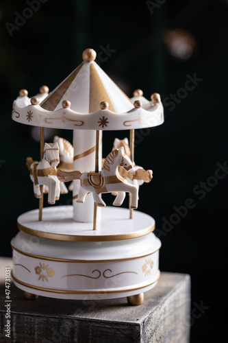 White vintage toy carousel with horses