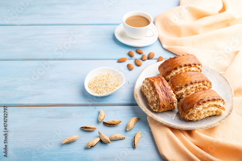 Traditional armenian dessert gata with cup of coffee on a blue wooden background. side view, copy space.