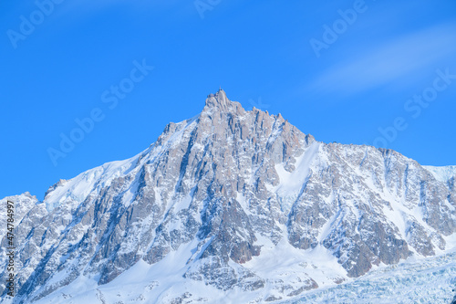 The Aiguille du Midi in the Mont Blanc massif in Europe, France, the Alps, towards Chamonix, in spring, on a sunny day.