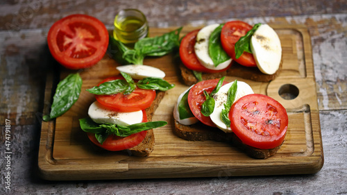 Selective focus. Caprese sandwiches on the board. Healthy snack. Italian food.