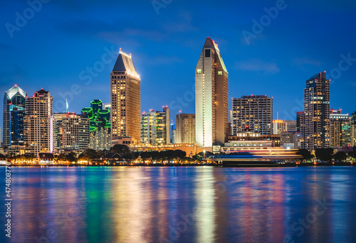 San Diego California skyline at night with reflections in water.