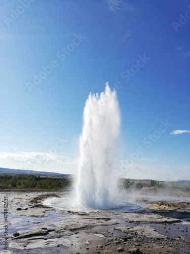 geyser expelling water on a blue background