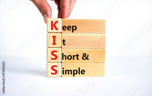 KISS keep it short and simple symbol. Concept words KISS keep it short and simple wooden blocks. Beautiful white table, white background. Business KISS keep it short and simple concept. Copy space.