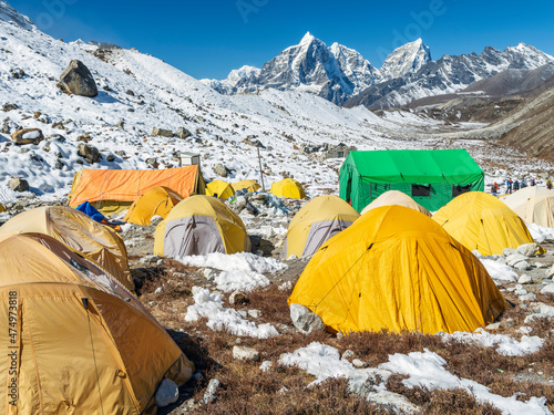 A lot of tents in alpinist base camp in valley Khumbu near summit Islandpeak in Nepal