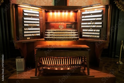 A traditional pipe organ illuminated with lights