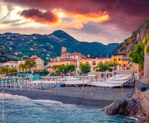 Picturesque summer cityscape of Minori town. Incredible sunset on Mediterranean cost. Amazing evening scene of Italy, Salerno region, Europe. Vacation concept background.