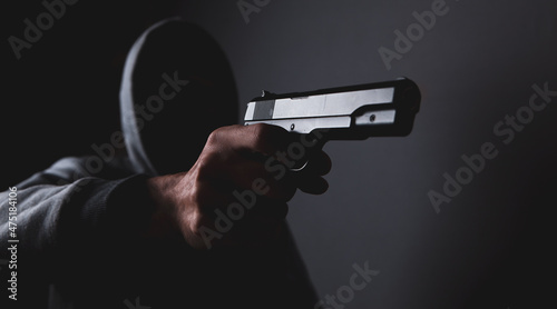 masked man holding a gun