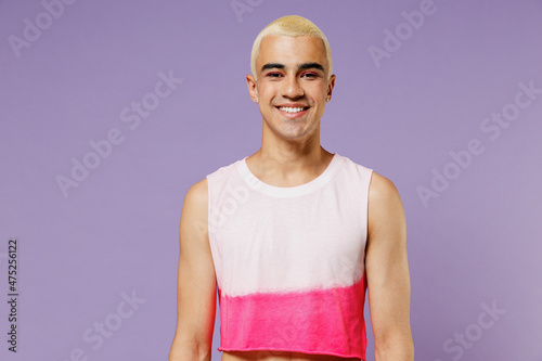 Young trendy blond hispanic latin gay man 20s with make up in fashionable bright pink top look camera isolated on plain pastel purple background studio portrait People lifestyle fashion lgbtq concept