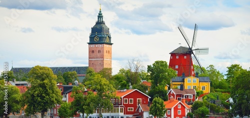 Panoramic cityscape from a sailing boat. Cathedral, traditional houses, windmill. Strängnäs, Mälaren lake, Sweden. Travel destinations, landmarks, sightseeing, cruise, culture