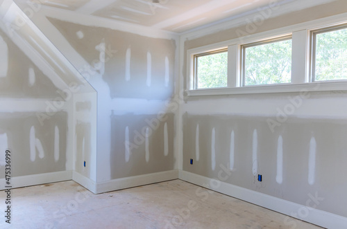 Finishing plastering drywall in ready for paint with new house