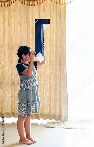 A girl looking through her DIY periscope