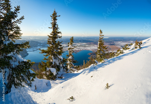 View towards lake Kochelsee and the foothills of the Alps near Munich. View from Mt. Jochberg near lake Walchensee during winter in the Bavarian Alps. Germany, Bavaria
