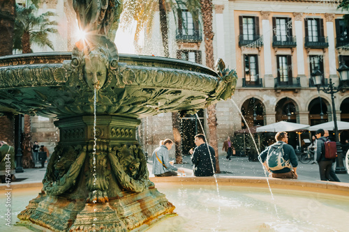 Beautiful historic fountain in Plaza Real in Barcelona, Spain. Famous square in Gothic quarter. Popular tourist attraction.